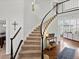 Elegant curved staircase featuring carpeted steps and black and white banister at 8346 Vivian St, Arvada, CO 80005