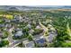 An aerial view of a lovely neighborhood with mature trees, manicured lawns and views of the mountains at 2384 Crestridge Dr, Castle Rock, CO 80104