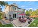 Backyard patio with outdoor kitchen, a dining area, and hot tub offers the ultimate outdoor living experience at 2384 Crestridge Dr, Castle Rock, CO 80104