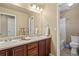 Bathroom features double sinks with dark wood cabinets and tile flooring with separate tub and shower at 2384 Crestridge Dr, Castle Rock, CO 80104
