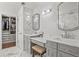 Bright bathroom featuring double vanities, decorative mirrors, and a walk-in closet on marble floors at 2384 Crestridge Dr, Castle Rock, CO 80104