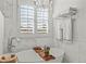 Elegant bathroom features a soaking tub with a caddy, window shutters and a rack of clean, white towels at 2384 Crestridge Dr, Castle Rock, CO 80104