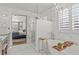 Spa-like bathroom featuring white marble, a walk-in shower, and a soaking tub with chandelier at 2384 Crestridge Dr, Castle Rock, CO 80104