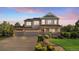 Charming two-story home featuring a large three-car garage and a welcoming front porch and professionally landscaped front yard at 2384 Crestridge Dr, Castle Rock, CO 80104