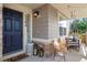 Inviting front porch with a charming swing, seating, and stylish decor, perfect for relaxing and enjoying the outdoors at 2384 Crestridge Dr, Castle Rock, CO 80104