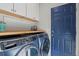 Bright laundry room with washer, dryer, and upper cabinets at 2384 Crestridge Dr, Castle Rock, CO 80104