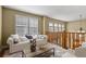 Bright living room with large windows, a comfortable sofa, and open access to the lower level at 2384 Crestridge Dr, Castle Rock, CO 80104
