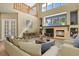Bright living room with a cozy fireplace and large windows at 2384 Crestridge Dr, Castle Rock, CO 80104