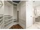 Organized walk-in closet with custom shelving, drawers, and storage, leading to a full bathroom at 2384 Crestridge Dr, Castle Rock, CO 80104