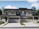 Attractive townhome with stone accents, a gray color palette, and a two car garage at 6770 Juniper Dr, Thornton, CO 80602