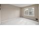 Simple carpeted bedroom with large window at 1673 S Fulton St, Aurora, CO 80247