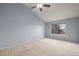 Bright bedroom with light blue walls and carpet at 1673 S Fulton St, Aurora, CO 80247