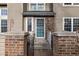 Townhome entry with brick pillars and a blue door at 1673 S Fulton St, Aurora, CO 80247