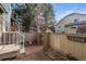 Small brick patio with potted plants and a gate at 1673 S Fulton St, Aurora, CO 80247