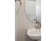 Stylish powder room with a unique round mirror and modern faucet at 14149 Deertrack Ln, Parker, CO 80134
