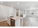 Open kitchen with an island featuring stainless steel appliances and views into the living room at 14149 Deertrack Ln, Parker, CO 80134