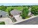 Aerial view showcasing a well-maintained home with lush landscaping and a convenient driveway, nestled in a desirable neighborhood at 6776 Salvia Ct, Arvada, CO 80007