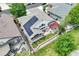 This aerial view showcases a home with solar panels, a patio, and a well-manicured backyard at 6776 Salvia Ct, Arvada, CO 80007