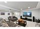 The basement living room features a large screen TV, comfortable sofas, and ample space for entertainment at 6776 Salvia Ct, Arvada, CO 80007