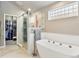 Modern bathroom with freestanding tub, glass shower, and walk-in closet at 6776 Salvia Ct, Arvada, CO 80007