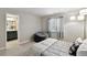This cozy bedroom is furnished with a plush bed, soft lighting, and an ensuite bathroom for added convenience at 6776 Salvia Ct, Arvada, CO 80007