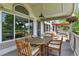 Relaxing covered deck featuring a rustic wood table set for six, ideal for enjoying outdoor dining and entertaining at 6776 Salvia Ct, Arvada, CO 80007