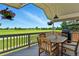 Inviting covered deck with golf course views, perfect for outdoor dining and relaxation with grill and charming floral accents at 6776 Salvia Ct, Arvada, CO 80007