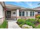 Inviting front porch with hanging flower baskets and brick accents at 6776 Salvia Ct, Arvada, CO 80007