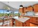 Bright kitchen features a large kitchen island with marble countertops and views of the golf course at 6776 Salvia Ct, Arvada, CO 80007
