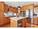 Beautiful kitchen with wooden cabinets, stainless steel appliances, and a marble countertop island at 6776 Salvia Ct, Arvada, CO 80007