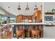 Modern kitchen with a quartz countertop, wood accents and decorative pendant lights at 6776 Salvia Ct, Arvada, CO 80007