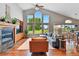 Bright living room with vaulted ceilings, fireplace and large windows overlooking the golf course at 6776 Salvia Ct, Arvada, CO 80007