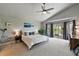 Spacious main bedroom with vaulted ceiling, large windows, and access to a private balcony at 6776 Salvia Ct, Arvada, CO 80007