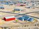 Aerial view showing home, detached garage and neighborhood at 767 S Main St, Byers, CO 80103