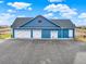 Three-car garage with additional storage space at 767 S Main St, Byers, CO 80103