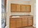 Laundry room with wooden cabinets and countertop at 767 S Main St, Byers, CO 80103