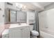 This bathroom features white tiling, a modern vanity with sink, a wall cabinet and a combined bathtub and shower at 1155 N Ash St # 1206, Denver, CO 80220