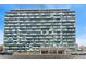Modern high-rise apartment building showcasing unique blue and white facade with street view at 1155 N Ash St # 1206, Denver, CO 80220