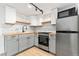 Updated kitchen with stainless steel appliances, sleek countertops, and stylish backsplash at 1155 N Ash St # 1206, Denver, CO 80220