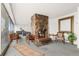 A grand lounge featuring a stone fireplace, comfortable seating, and floor-to-ceiling windows at 1155 N Ash St # 1206, Denver, CO 80220