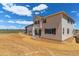 Back exterior view features a spacious backyard and a two-story home with neutral siding and dark shutters at 459 S Salida St, Aurora, CO 80017