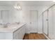 Bright bathroom featuring a double sink vanity with quartz countertop and a glass enclosed shower at 459 S Salida St, Aurora, CO 80017