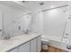 Well-lit bathroom features double sinks with quartz countertop and a shower over tub at 459 S Salida St, Aurora, CO 80017
