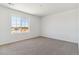 Spacious bedroom with neutral carpet and a large window providing ample natural light at 459 S Salida St, Aurora, CO 80017