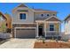 Charming two-story home featuring stone accents, a covered porch, and an attached two-car garage at 459 S Salida St, Aurora, CO 80017