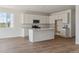 Modern kitchen featuring white cabinets, quartz countertops, and stainless steel appliances at 459 S Salida St, Aurora, CO 80017