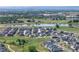 Panoramic aerial view features a community with ponds, lush landscapes and surrounding plains and mountains at 836 Sundance Ln, Erie, CO 80516