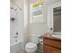 Bright bathroom features a shower-tub combination, granite countertop vanity, and a window at 836 Sundance Ln, Erie, CO 80516