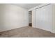 Cozy bedroom with plush carpet, neutral walls, a closet, and an entry door at 836 Sundance Ln, Erie, CO 80516