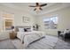 Bright bedroom featuring a ceiling fan, large window, neutral walls, and stylish decor at 836 Sundance Ln, Erie, CO 80516